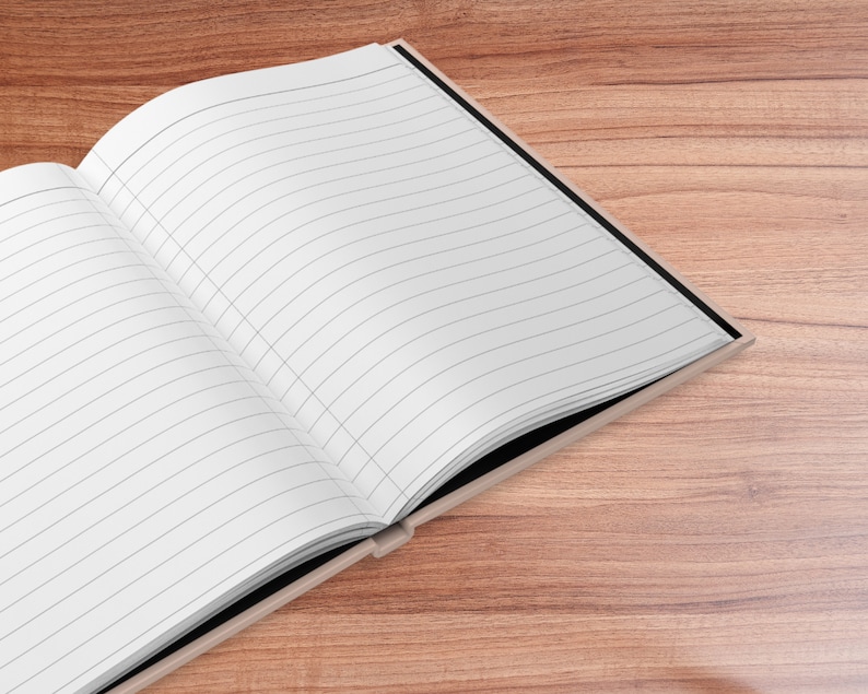 May include: A black and white lined notebook with a black cover is open on a wooden surface.