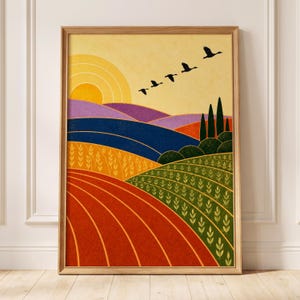 May include: A framed wall art print featuring a landscape with a yellow sun, rolling hills in shades of purple and blue, and fields of orange and green. Five black birds fly in a diagonal formation across the sky above tall green trees.