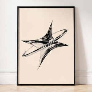 May include: A framed wall art print featuring a central, abstract, chrome-like metallic object with sharp, pointed edges and a surrounding ring structure. The object displays high-contrast reflections against a solid, light beige background.