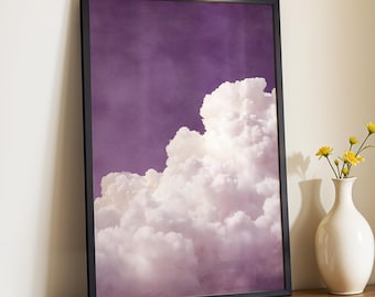 May include: Framed art print featuring a dramatic cloudscape. The artwork showcases a large, fluffy cloud formation against a deep purple sky. The print is encased in a sleek black frame, adding a modern touch to the serene scene.