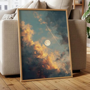May include: A framed art print featuring a celestial scene. The artwork depicts a full moon, a streaking meteor, and dramatic clouds in shades of orange, yellow, and blue. The wooden frame adds a natural touch to the artwork.