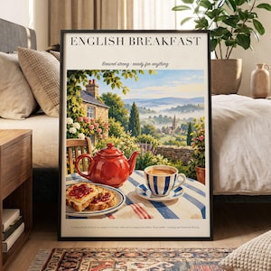 May include: A framed wall art print titled ENGLISH BREAKFAST with the text Brewed strong - ready for anything. The illustration depicts a red teapot, a blue and white striped teacup, and toast with jam on a table overlooking a scenic countryside.