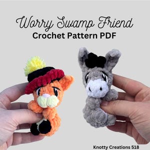 May include: Image of two crocheted Worry Swamp Friends. One is orange with a hat, the other is gray. The text "Worry Swamp Friend Crochet Pattern PDF" is at the top. The creator's name, Knotty Creations 518, is at the bottom.