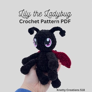 May include: A black crochet ladybug toy with big eyes and red wings. The text "Lily the Ladybug Crochet Pattern PDF" is above the toy. The ladybug is held in a hand against a light grey background.