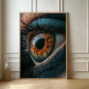 May include: Close-up of a human eye with blue eyeshadow and an orange iris. The eye is looking directly at the viewer.