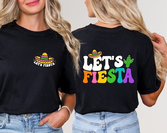 May include: Black t-shirt with "Let's Fiesta" text in rainbow colors and a cactus graphic on the back. The front of the shirt has a small sombrero graphic with "Let's Fiesta" text.