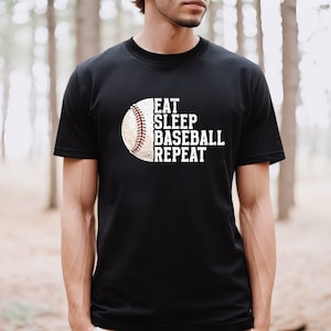 May include: Black t-shirt with a white baseball graphic and the text "Eat Sleep Baseball Repeat".
