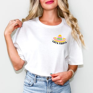 May include: White t-shirt with a yellow, pink, and green sombrero graphic and the text "Let's Fiesta".