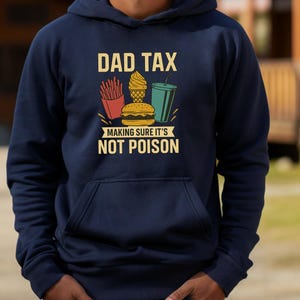 May include: Navy blue hooded sweatshirt featuring the text "DAD TAX" above a graphic of fries, ice cream, a burger, and a drink. The phrase "MAKING SURE IT'S NOT POISON" is printed below the illustrations.