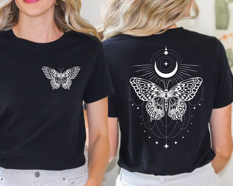 May include: Two black t-shirts featuring a white butterfly design. One shirt has a simple butterfly design on the front, while the other has a more elaborate butterfly design with a crescent moon and stars on the back.