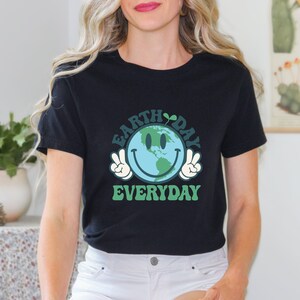 May include: Black t-shirt with a green and blue graphic of a smiling Earth with peace signs. The text "Earth Day Everyday" is printed below the graphic.