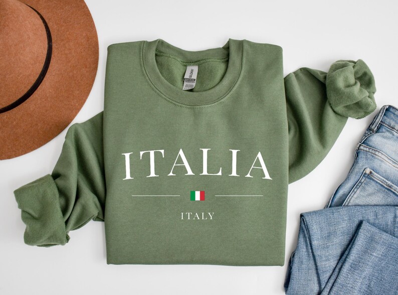 May include: A green sweatshirt with the word "ITALIA" in white letters and the word "ITALY" below it. The Italian flag is between the words.