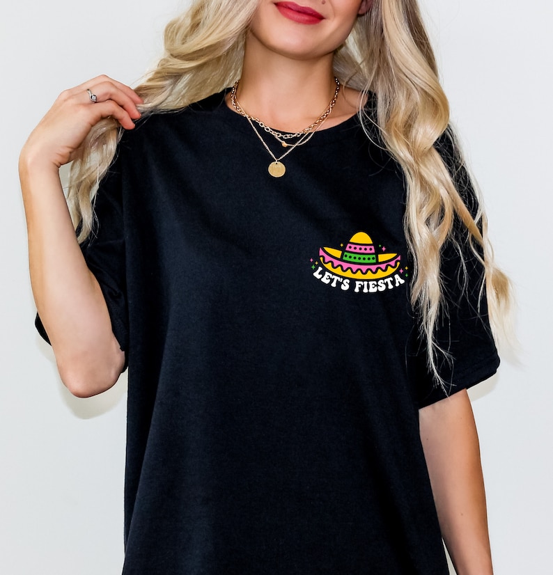 May include: Black t-shirt with a colorful graphic of a sombrero and the text "Let's Fiesta".