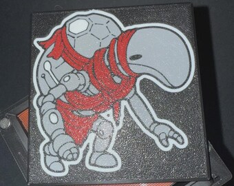 May include: A gray robot character with a red scarf is featured on a black, textured surface. The robot has a rounded head and body with mechanical details. The image is a close-up, highlighting the character's design and the texture of the surface.