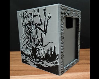 May include: A gray, cube-shaped storage box with a detailed black illustration of a creature and a cityscape. The box has a handle cutout and decorative border. The design is 3D printed.