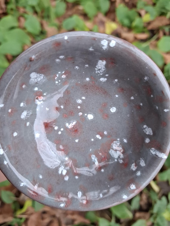 2 dip bowls made of red clay with white and red dots on a light grey background. Handmade.