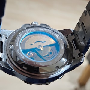 UGLE English Masonic kinetic automatic watch without G inside square and compasses on face.