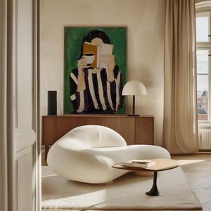 May include: A modern living room scene featuring a white, curved sofa, a small wooden coffee table, and a large painting of a person reading. A wooden cabinet and a white lamp are also visible.