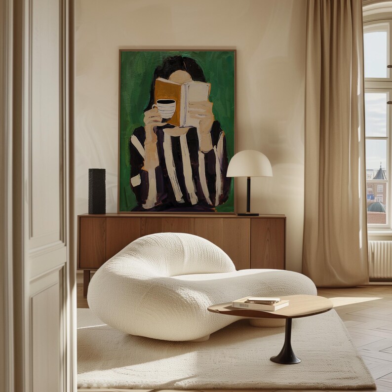 May include: A modern living room scene featuring a white, curved sofa, a small wooden coffee table, and a large painting of a person reading. A wooden cabinet and a white lamp are also visible.
