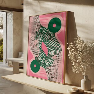Peut inclure: Impression d'art abstrait avec un fond rose et un motif à pois verts et blancs. L'œuvre présente deux grands cercles verts et une forme rose centrale. L'impression est encadrée dans un cadre doré et est appuyée contre un mur.