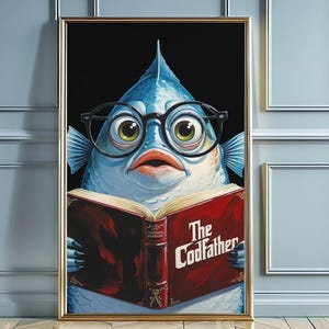 May include: A framed art print featuring a blue fish wearing glasses and reading a book titled "The Codfather." The fish has large eyes and a surprised expression. The book is red with gold lettering. The frame is gold.