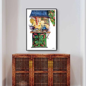 May include: Watercolor painting of a street food stall with a blue awning and green and red accents. The stall features a table with various items, including a teapot and jars. The artwork is framed and displayed above a wooden cabinet.