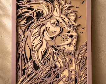 May include: A multi-layered laser-cut wood wall art piece featuring a profile view of a lion's head surrounded by tall grass. The design uses shades of tan, beige, and black to create depth, with silhouettes of birds flying in the background.