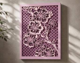 May include: A rectangular wall art piece featuring a layered, three-dimensional cutout design of cherry blossom branches. The artwork displays shades of light and dark purple, set against a grid-patterned background within a solid purple frame.