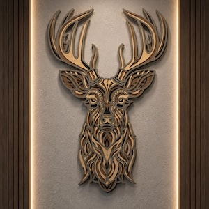May include: A multi-layered wooden wall art piece depicting a deer head with intricate, symmetrical cut-out patterns. The design features various shades of brown and tan wood, creating a dimensional effect with detailed antlers and facial features.