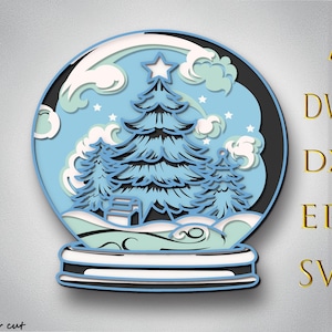 May include: A layered paper art design of a snow globe featuring a Christmas tree, clouds, and stars. The globe is primarily blue, white, and black, with a star on top of the tree. The design includes the text "AI, DWG, DXF, EPS, SVG" and "Bylaser cut".