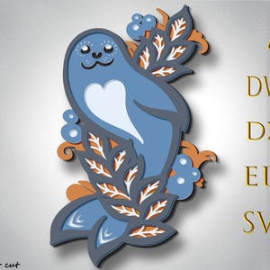 May include: A blue and white seal with a heart-shaped design is surrounded by orange and white leafy branches. The seal is in a stylized, paper-cut design.