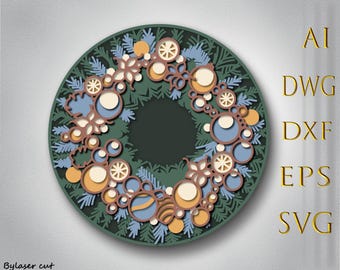 May include: A layered, circular Christmas wreath design in shades of green, brown, blue, and yellow. The wreath features intricate cut-out details of ornaments and foliage. The image also includes text on the right side that says "AI, DWG, DXF, EPS, SVG".
