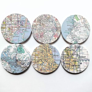 May include: Set of six round coasters featuring colorful maps of different cities, including Miami, Vancouver, Chicago, and Denver.