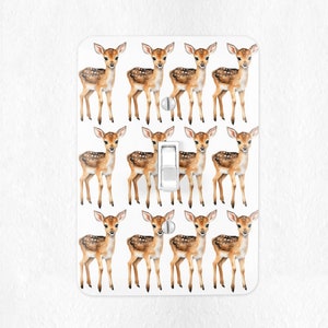 May include: White light switch cover with a repeating pattern of brown and white fawn illustrations.