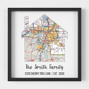 May include: A framed print featuring a map of Charlotte, North Carolina, shaped like a house. The text "The Smith Family" and "2220 CHERRY TREE LANE | EST. 2020" is printed below the map.