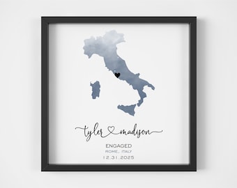 May include: A watercolor illustration of Italy with a black heart marking the location of Rome. The text below reads "Tyler & Madison Engaged Rome, Italy 12.31.2025".