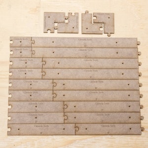 May include: A set of wooden jigsaw pieces for constructing a wooden tool organiser. The pieces are labelled with measurements in inches, including 2, 3, 4, 5, 6, 7, 9, and 10 inches.