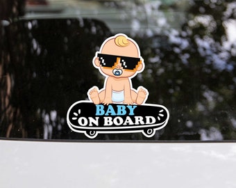 May include: A black and white sticker featuring a cartoon baby wearing sunglasses and a nappy riding a skateboard. The text "BABY ON BOARD" is written on the skateboard.