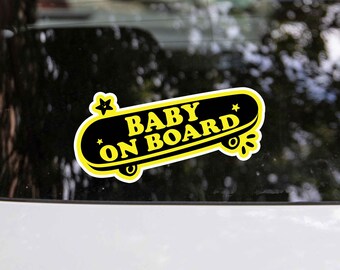 May include: A yellow and black car sticker with a skateboard design that says "Baby on Board".