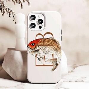 May include: White iPhone case with a brown letter "B" and a detailed illustration of a red and brown fish.