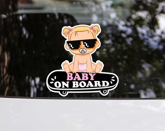 May include: A black and white sticker featuring a cartoon baby wearing sunglasses and a pink dummy. The baby is sitting on a skateboard with the text "BABY ON BOARD" in pink letters.