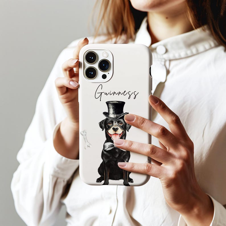 May include: White phone case featuring a black dog wearing a top hat and bow tie. The word "Guinness" is written above the dog. The case has a glossy finish and is designed for a smartphone.