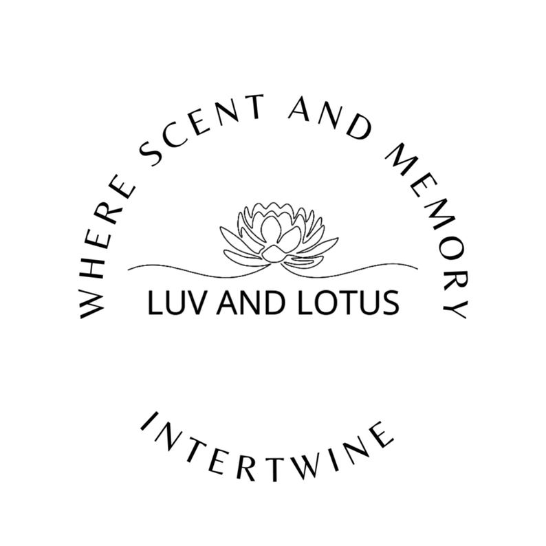 May include: A black and white circular logo featuring a line-art lotus flower centred above the text LUV AND LOTUS. The words WHERE SCENT AND MEMORY are arched above the flower, and the word INTERTWINE is positioned in an arc below the text.