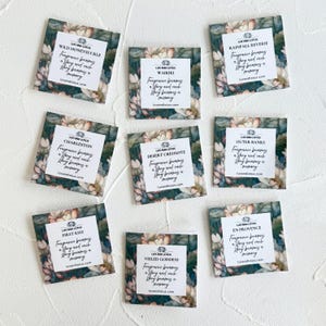 May include: Eight square fragrance sample cards featuring a floral lotus pattern in shades of green, pink, and white. Each card displays the Luv and Lotus logo, a unique scent name, and the text: Fragrance becomes a story and each story becomes a memory.