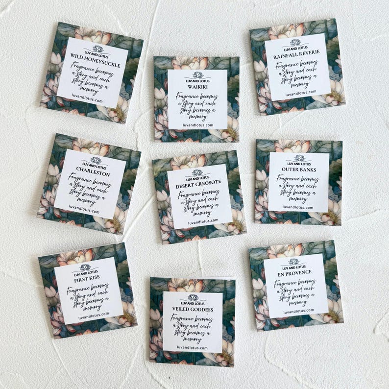 May include: Eight square fragrance sample cards featuring a floral lotus pattern in shades of green, pink, and white. Each card displays the Luv and Lotus logo, a unique scent name, and the text: Fragrance becomes a story and each story becomes a memory.