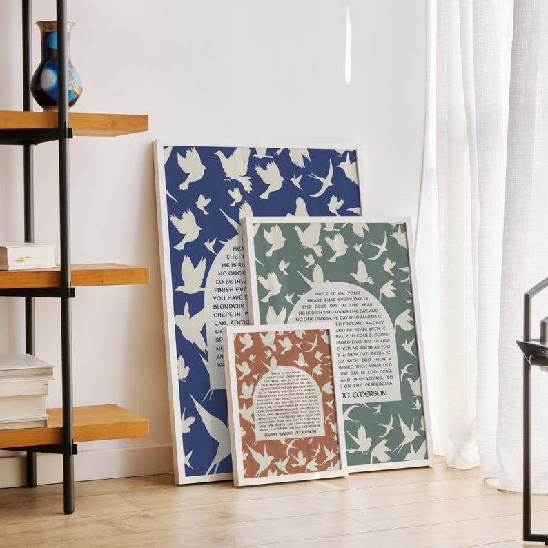 May include: Three framed prints with a blue, green, and orange background. Each print features a white silhouette of birds flying. The orange print includes a quote by Ralph Waldo Emerson: "Where is it on your heart, that every day is a new beginning?"