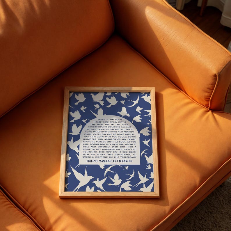 May include: A framed print with a blue background and white silhouettes of birds. The print features a quote by Ralph Waldo Emerson: "While it is on your head, the mere day is your year. He is rich who owns the day and no one owns the day who allows it to be invaded with worry and anxiety. Finish every day and be done with it. You have done what you could. Some blunders and absurdities no doubt crept in; forget them as soon as you can. Tomorrow is a new day; begin it well and serenely, with too high a spirit to be cumbered with your old nonsense. This new day is too dear, with its hopes and invitations, to waste a moment on the yesterdays."