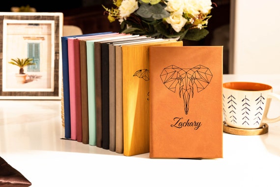 Hand-stitched leather journal with a custom animal origami motif stamped on the cover — way more tactile and personal than a printed notebook.