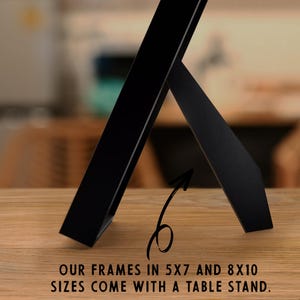 May include: Black picture frame with a built-in easel stand. Our frames in 5x7 and 8x10 sizes come with a table stand.