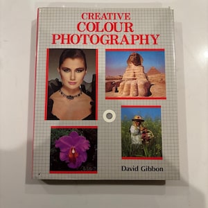 May include: A vintage book titled "Creative Colour Photography" by David Gibbon. The cover displays a grid pattern with four inset images: a woman, the Sphinx, a purple orchid, and a person in a field.
